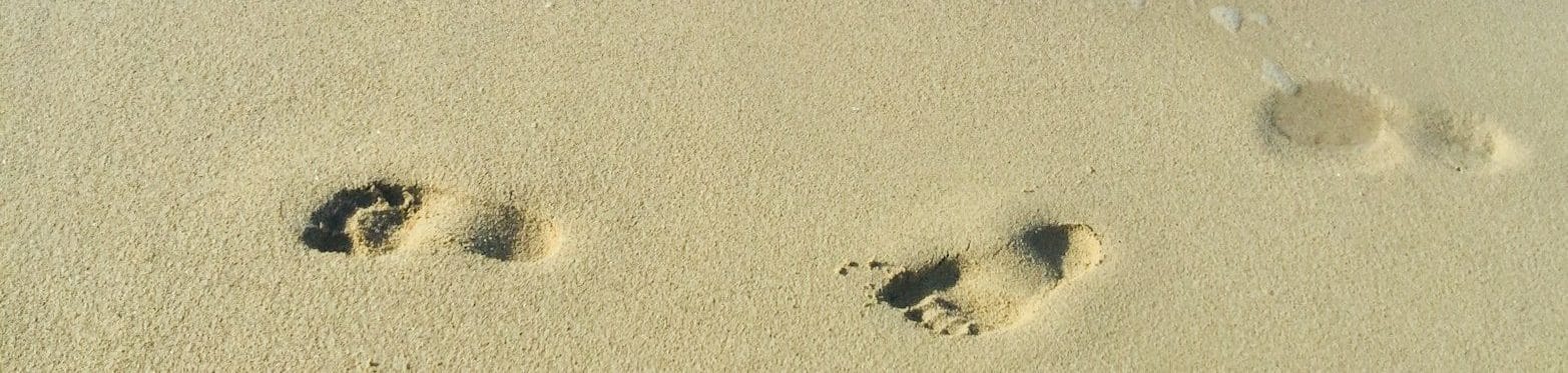 footprints on sand during daytime